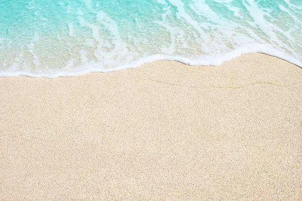 Soft wave of ocean on the sandy beach Soft wave of blue ocean on sandy beach. Background. waters edge stock pictures, royalty-free photos & images