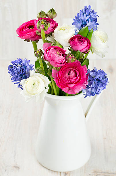 istock ranunculus and hyacinth flowers in a pitcher 579409378