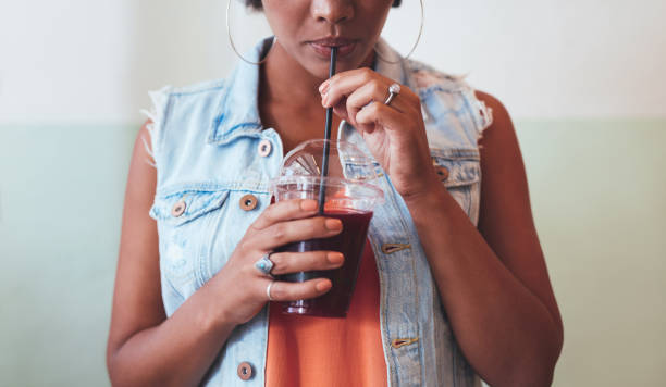 istock African woman drinking juice 579409672