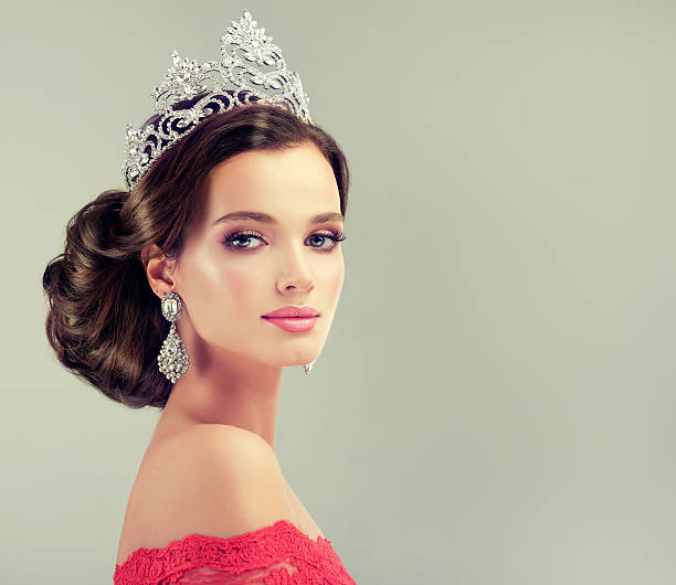 Model in a red gown and crown on her head. stock photo