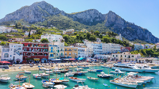 Сapri, Italy - May 31, 2016: Capri Island Landscape, Marina Grande harbour and mountains.