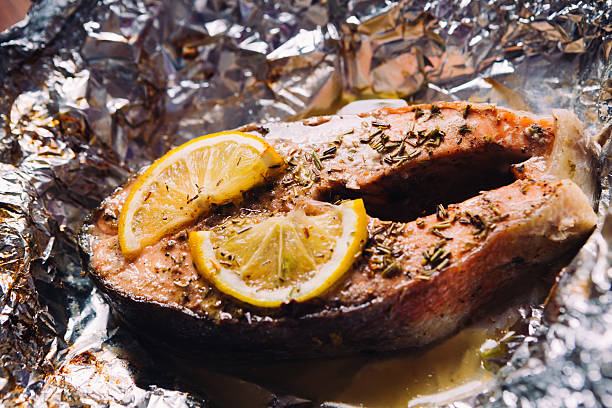istock fish steak baked with lemon and herbs in foil 579414680