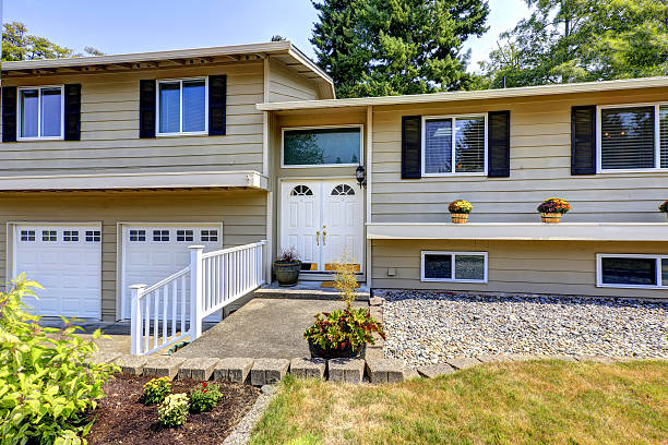 istock Beige siding  house exterior with white trim. 579415584