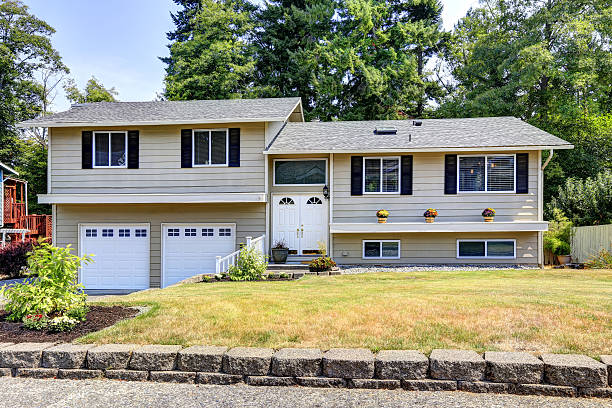 istock Beige siding  house exterior with white trim. 579415950