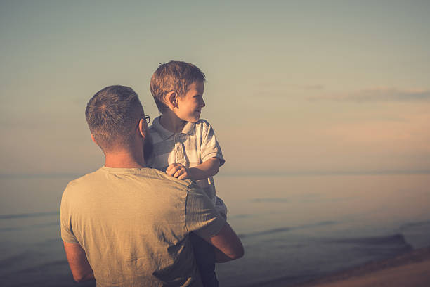 istock Dad and son enjoying the sea views 579416244