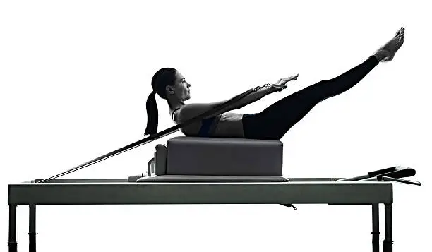 Photo of woman pilates reformer exercises fitness isolated