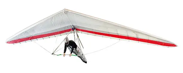 Hang glider soaring the thermal updrafts suspended on a harness below the wing, isolated on white