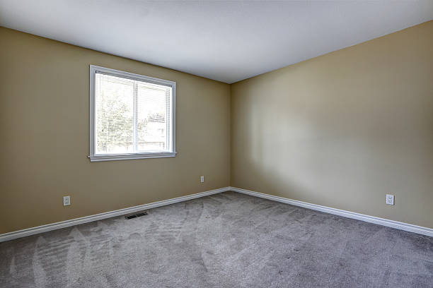 istock Gray Empty room interior with one window and carpet floor. 579416800