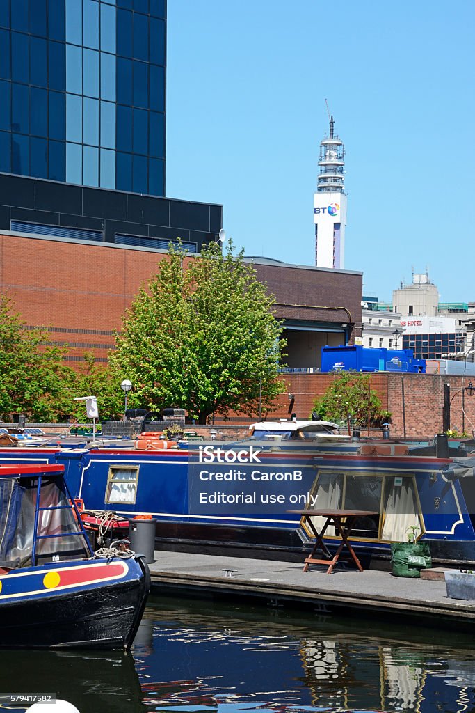 Boats in Gas Street Basin, Birmingham. Birmingham, United Kingdom - June 6, 2016: Narrowboats at Gas Street Basin with the BT tower to the rear, Birmingham, England, UK, Western Europe. Architecture Stock Photo