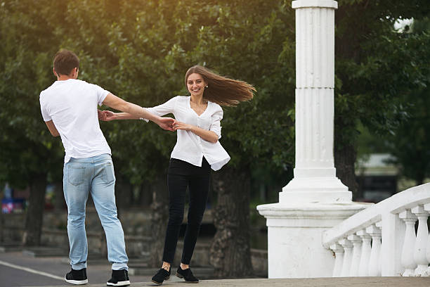 istock couple having fun on a bridge in the park 579419284