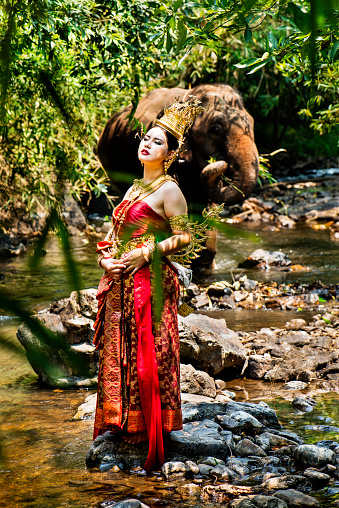 Tradtionally dressed Thai model with an elephant.