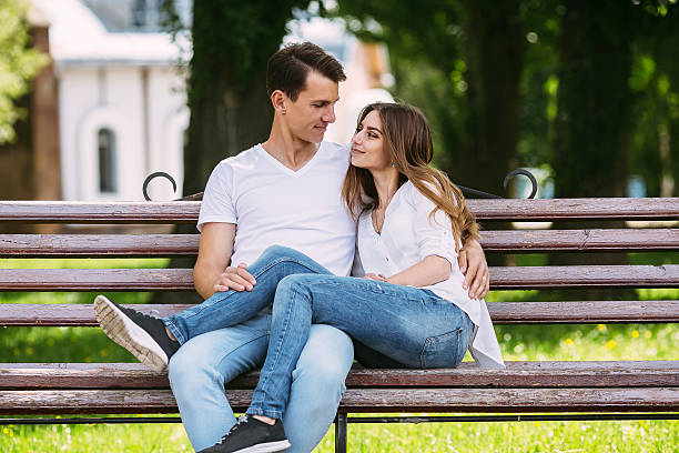 istock man and woman on a bench in the park 579419476