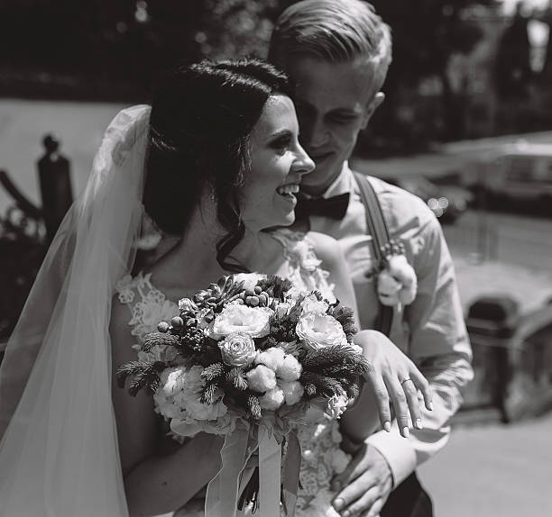 istock bride and groom posing on the streets 579421048