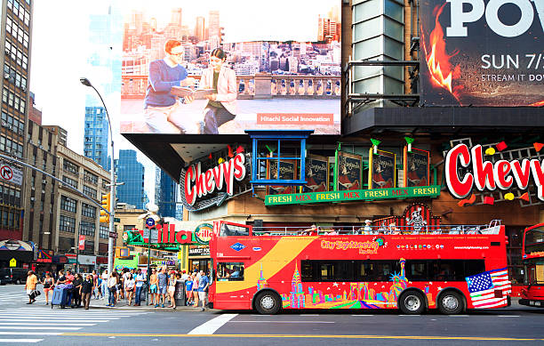 Tourism Image in New York New York, NY, USA July 23, 2016: Tourism Image in New York: Tourist bus on the intersection of 42nd St and 8 Av in Manhattan.  42nd street stock pictures, royalty-free photos & images