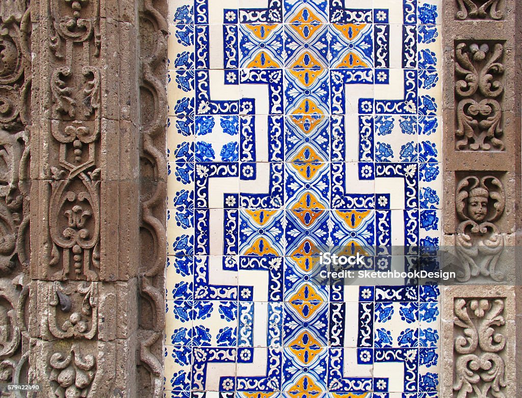 Detail of Mexican building with carved stone and painted tiles Deatil of Casa de los Azulejos in Mexico CIty, Mexico with blue and yellow painted tile facade and carved stone details Mexico City Stock Photo