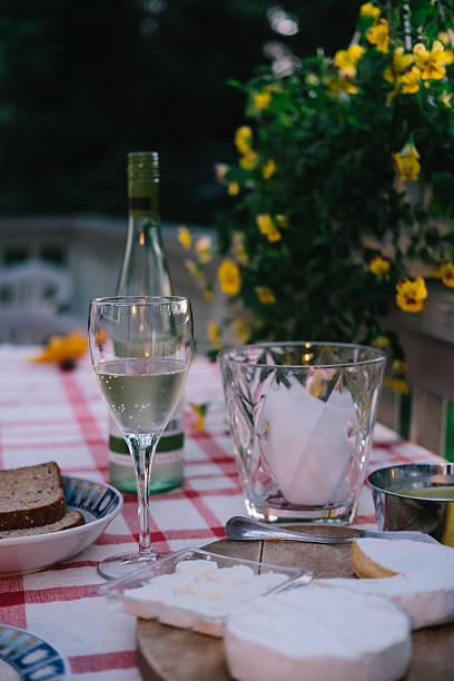 istock Cheese with white wine and flowers 579424448