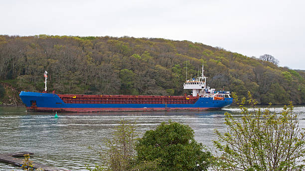 Cargo ship navigating the Truro river UK A general cargo ship makes its way up the Truro river en route to the river Fal. Access to and from the ancient port of Truro is severely depth restricted ballast water stock pictures, royalty-free photos & images