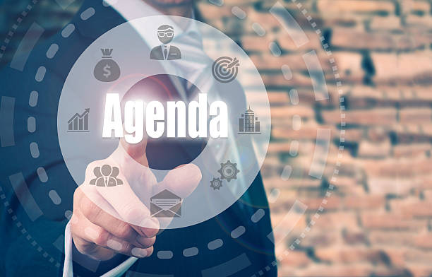 Businessman selecting a Agenda Concept button A businessman selecting a Agenda Concept button on a clear screen. agenda stock pictures, royalty-free photos & images