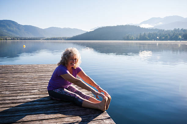 istock Senior aged woman stretching 579427234