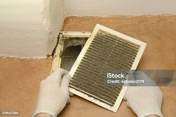 Man Removes Dust Ventilation Grilles Stock Photo - Download Image Now - Air Duct, Cleaning, Dirty