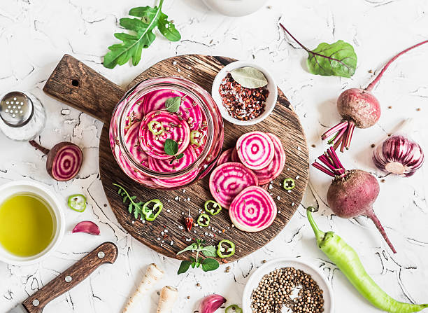 Cooking the pickled beets. Beets and spices Cooking the pickled beets. Beets and spices on a rustic cutting board on light background pickled turnip stock pictures, royalty-free photos & images