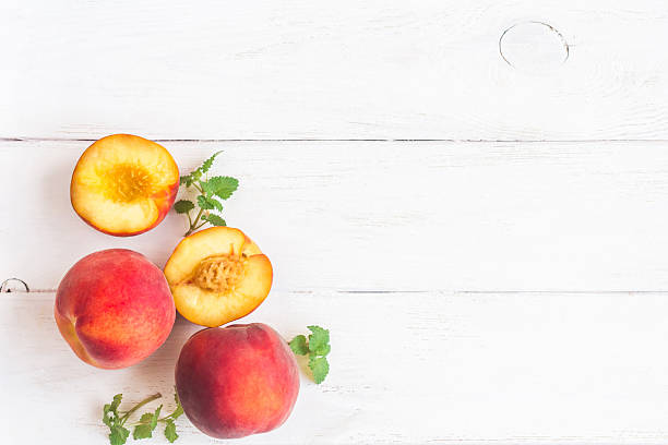 Fresh peaches on white background, top view, flat lay