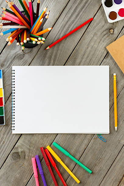 istock Notepad In The Frame Of Colored Pencils And Paints 579428472