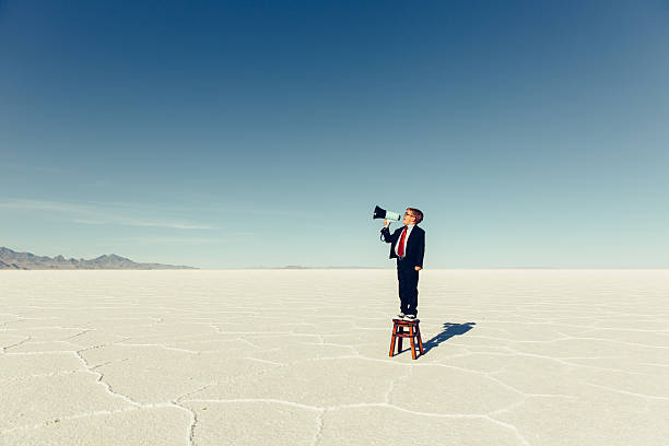 Young Boy Businessman Shouts Through Megaphone