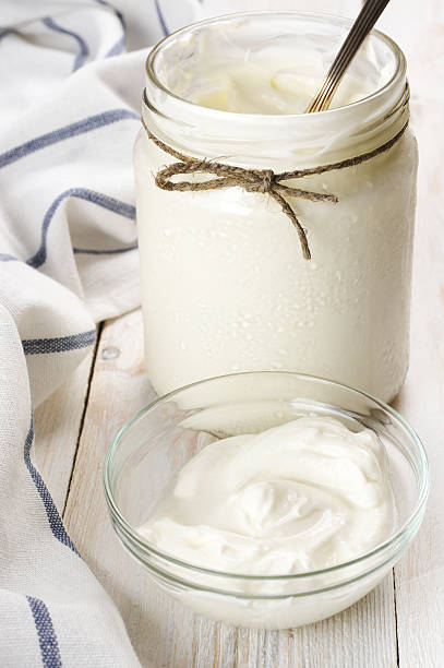 istock Sour cream in jar and bowl 579430596