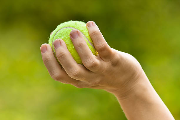 istock hand with tennis ball 579431300