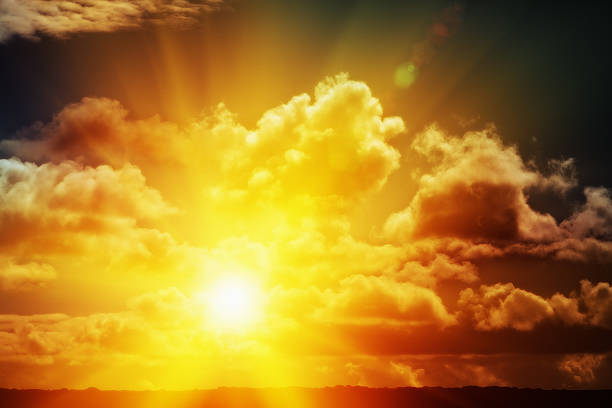 istock Glorious golden rising or setting sun with fluffy clouds 579431356