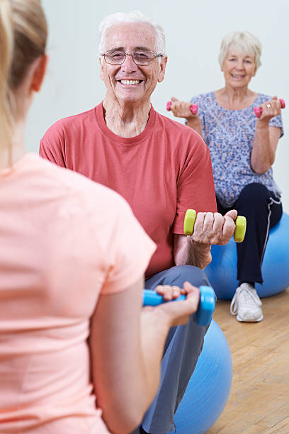 istock Seniors At Fitness Class With Instructor 579431606