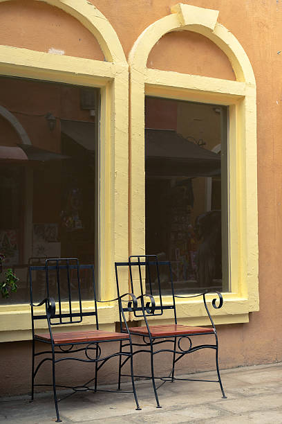 istock Steel chairs against yellow arch windows 579432300