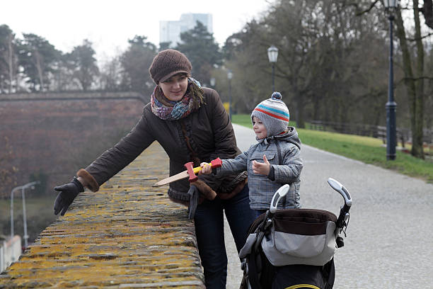 istock Mother shows wall thickness to her son 579432356