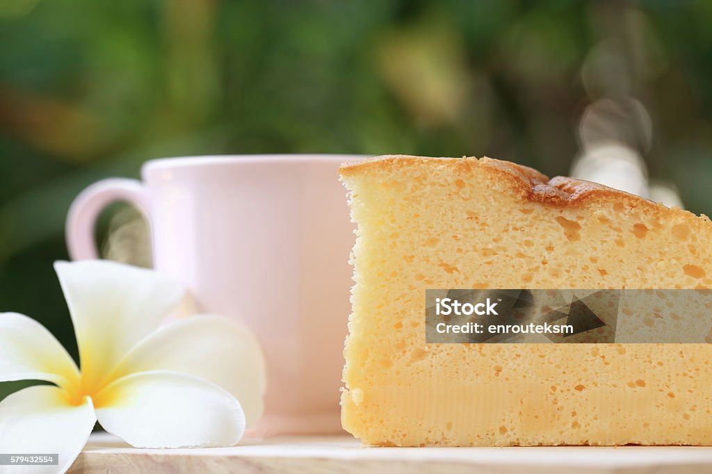 Japanese style Cheesecake and cup of coffee with garden background. Pieces of Japanese style Cheesecake and cup of coffee with green garden background. Cheesecake Stock Photo