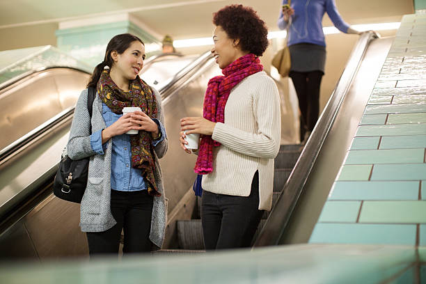 istock Female friends on escalator at subway station 579433492