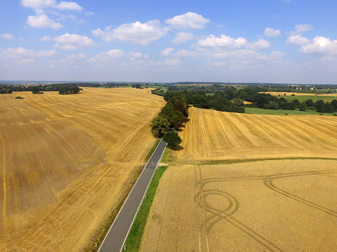 Aerial view of a road with golden cornfields in germany