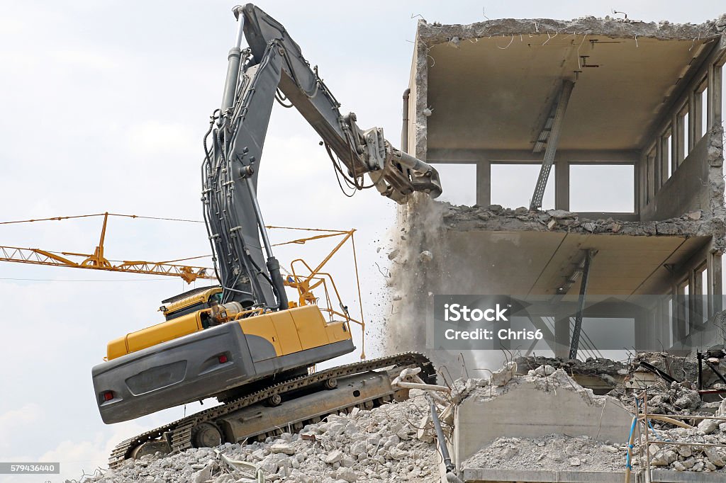 Wham Bam A large, industrial, heavy piece of machinery, smacks apart an old building, which is completely gone in a matter of hours. Absence Stock Photo