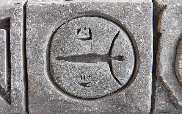 istock decorative gray stone wall with symbols and hieroglyphs close-up 579438126