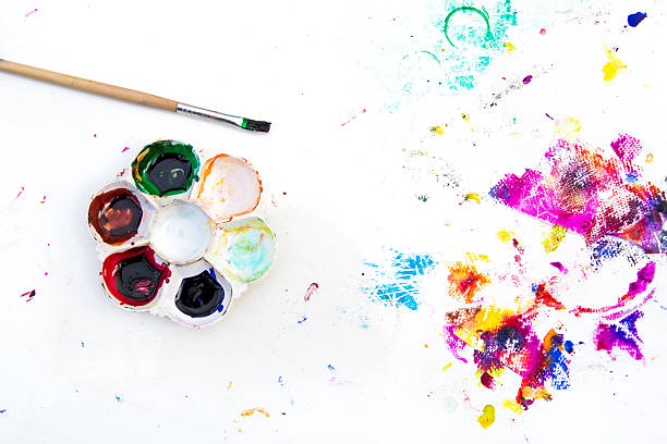 istock Palette and paint brush on paint-stained table. 579440374