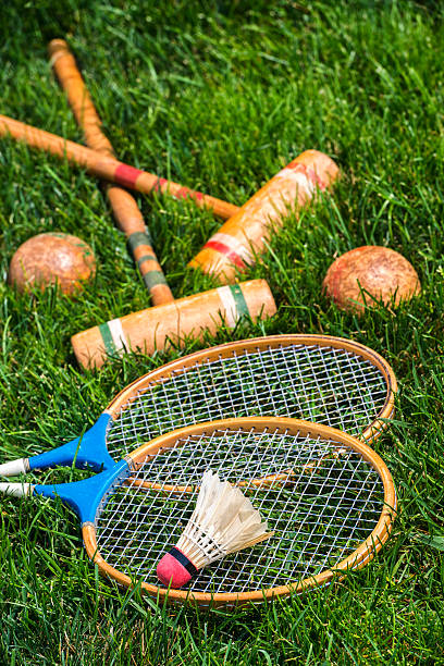 istock Vintage badminton rackets and croquet mallets lying in grass 579441374