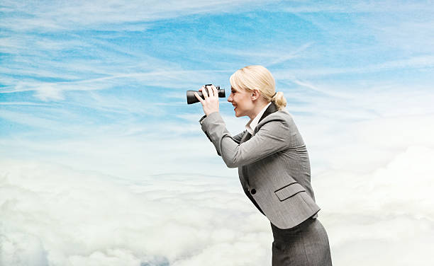 istock Smiling businesswoman searching with binocular 579444844