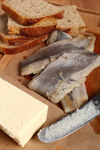 istock Making sandwiches with pickled herring and butter 579446766