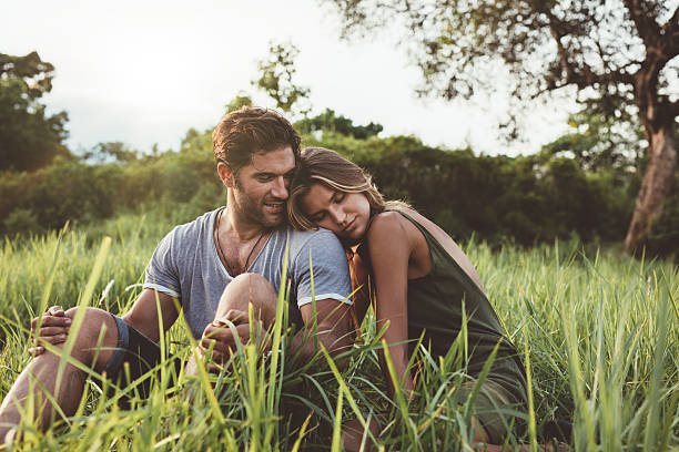 istock Romantic young couple relaxing in meadow 579447126