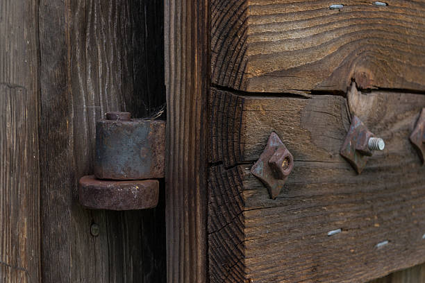 istock Rusty hinge in a wooden door 579730772