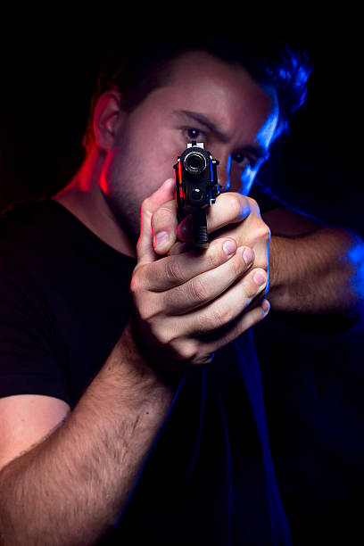 istock Cop or Criminal Holding a Gun 579732392