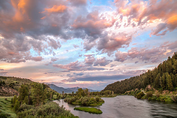 Sunset over an Idaho River The Snake River flows through Swan Valley, Idaho under a colorful sky at sunset. idaho stock pictures, royalty-free photos & images