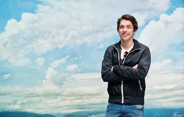 istock Smiling man standing with arms crossed 579732960