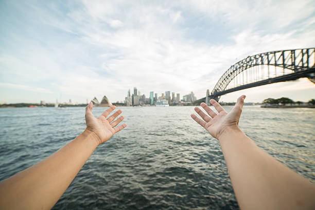 istock Person's arms stretch towards Sydney skyline, Australia 579732986