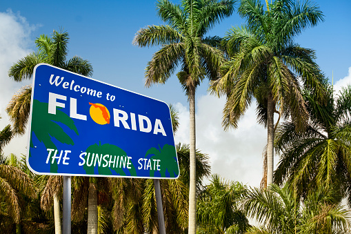 Low angle tropical landscape with a welcome sign to hot weather